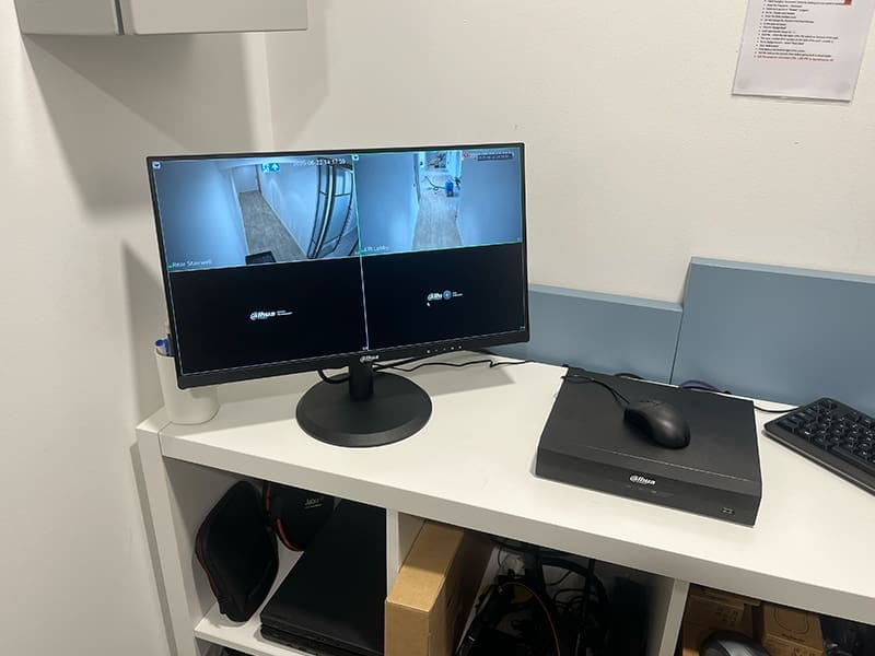 desk with two monitors and a keyboard