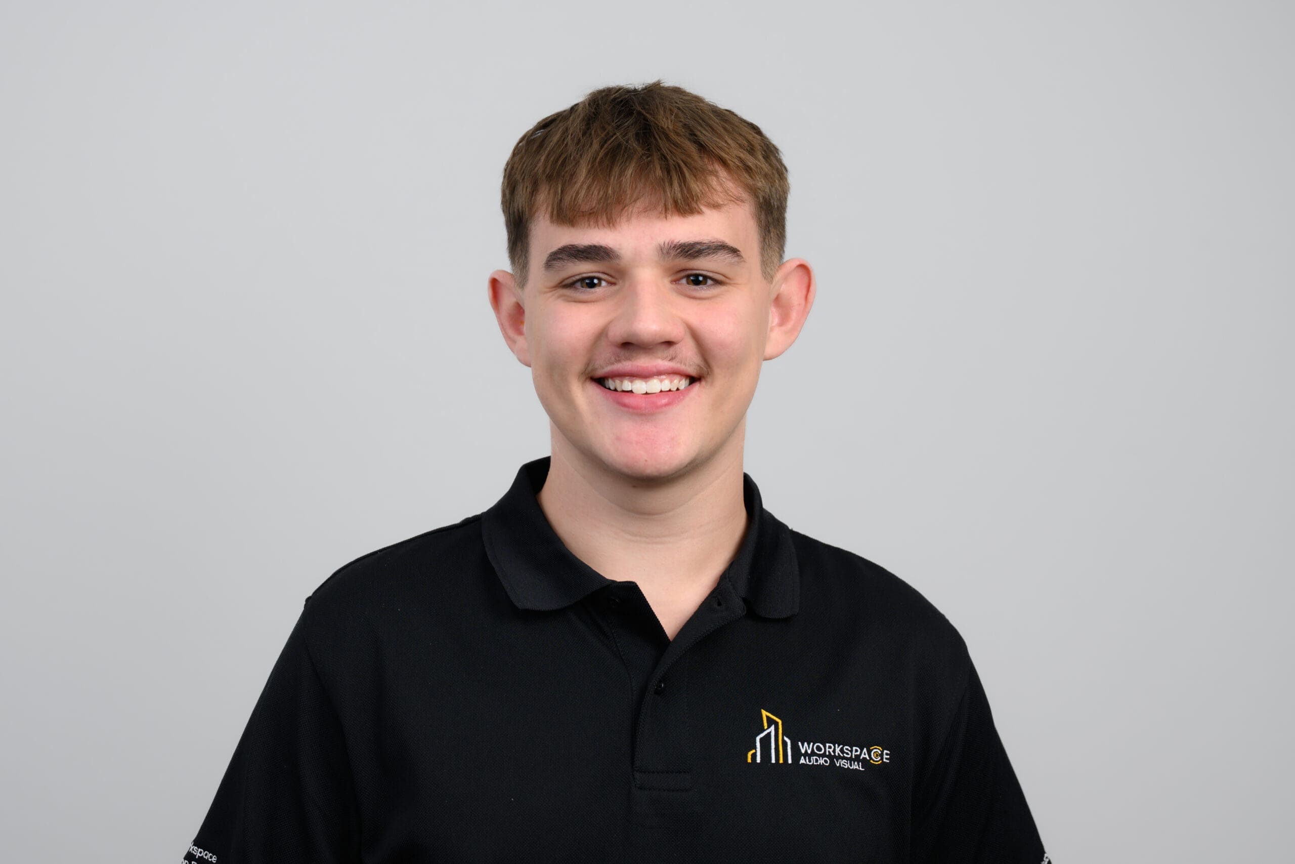 young man wearing a black polo shirt