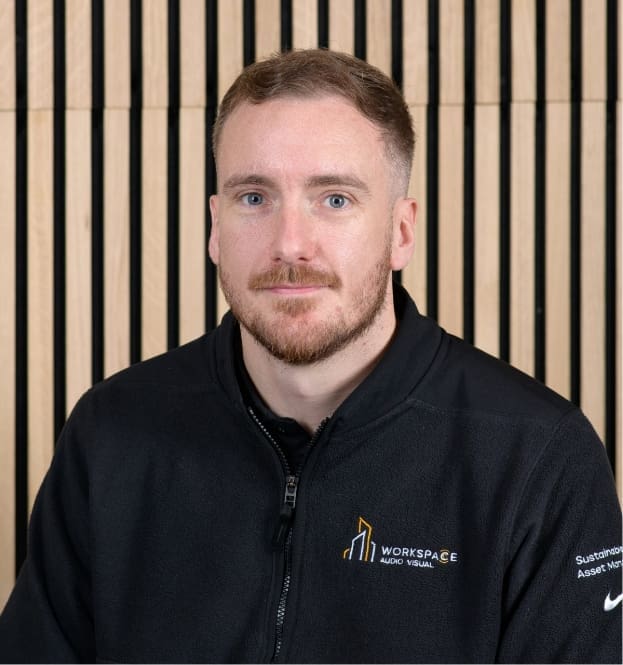 man in a black jacket is posing for a picture