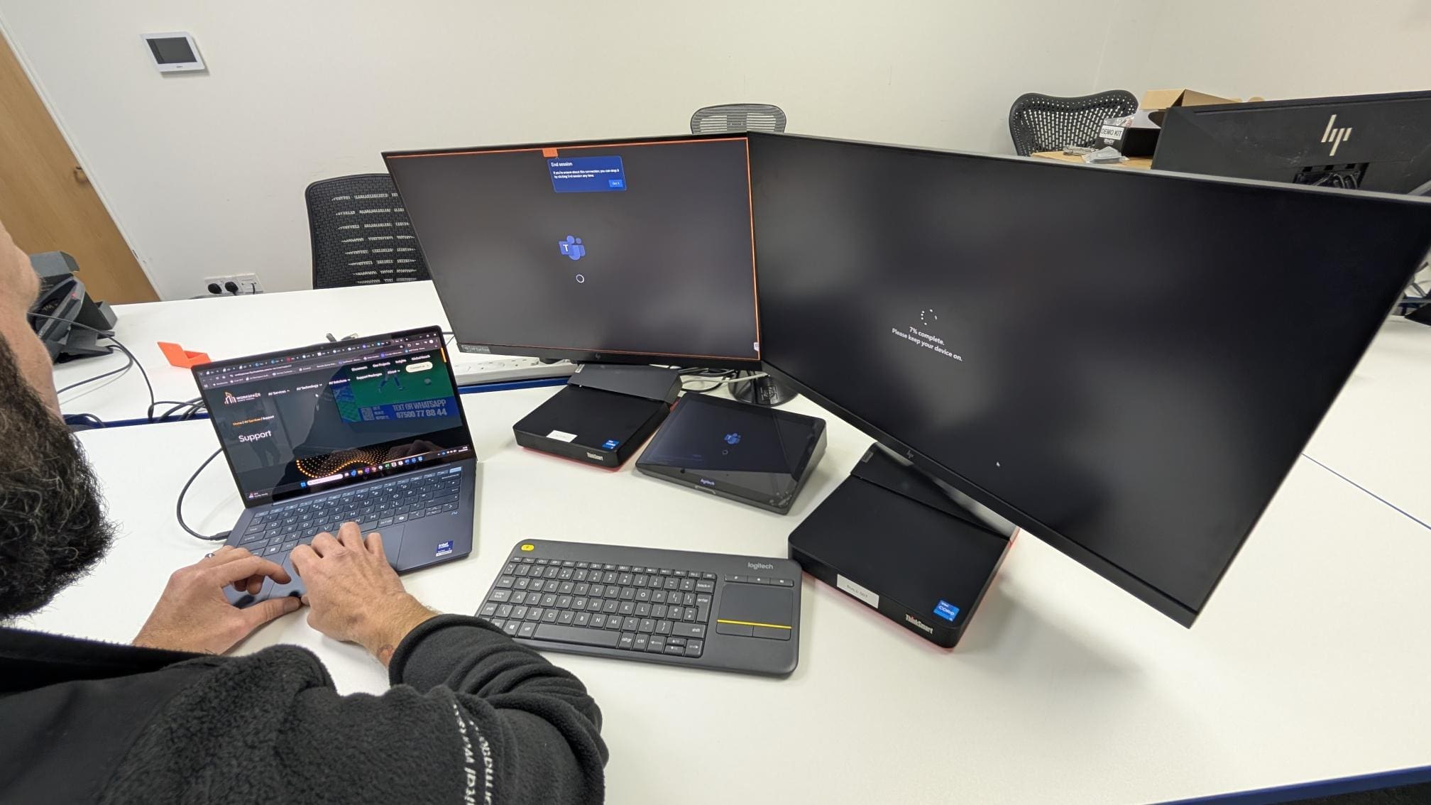 man sitting at a desk working on a laptop